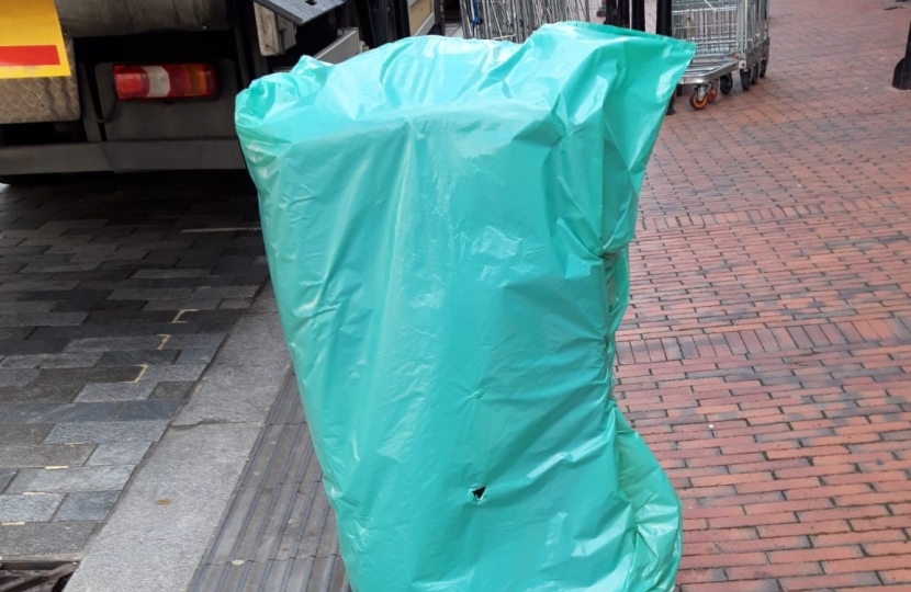 Bin covered in green bag in Purley High Street