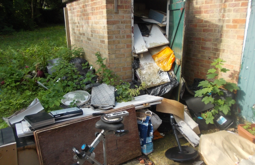 Rear of the property, piles of rubbish. 